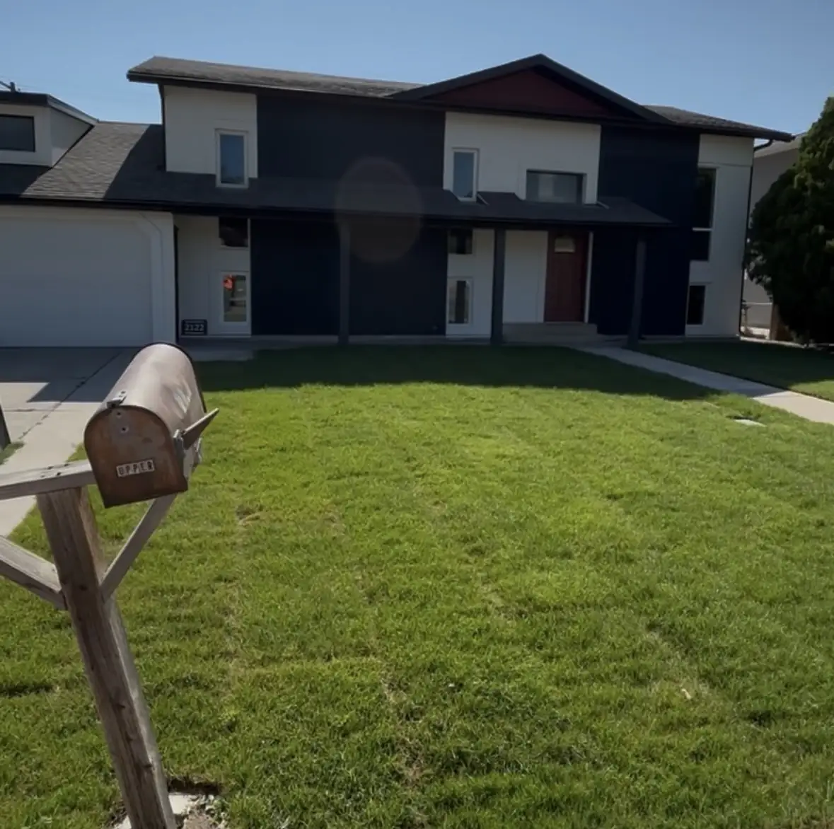New sod front lawn and walkway at a newer two-story home