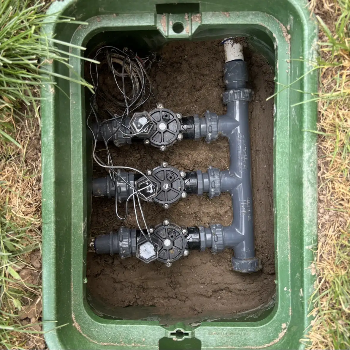 Rebuilt sprinkler valve manifold inside a valve box